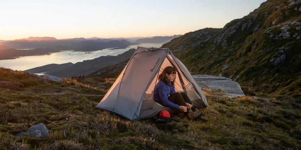 person in their backpacking tent