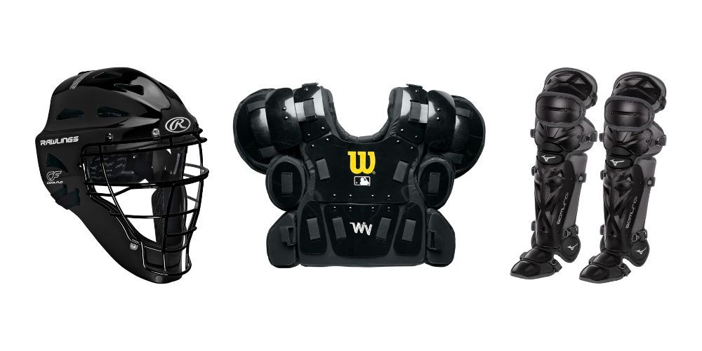 A baseball helmet , catcher 's chest protector , and leg pads on a white background.