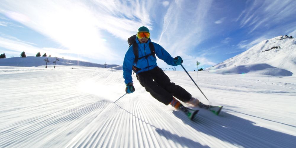 A person is skiing down a snow covered slope.