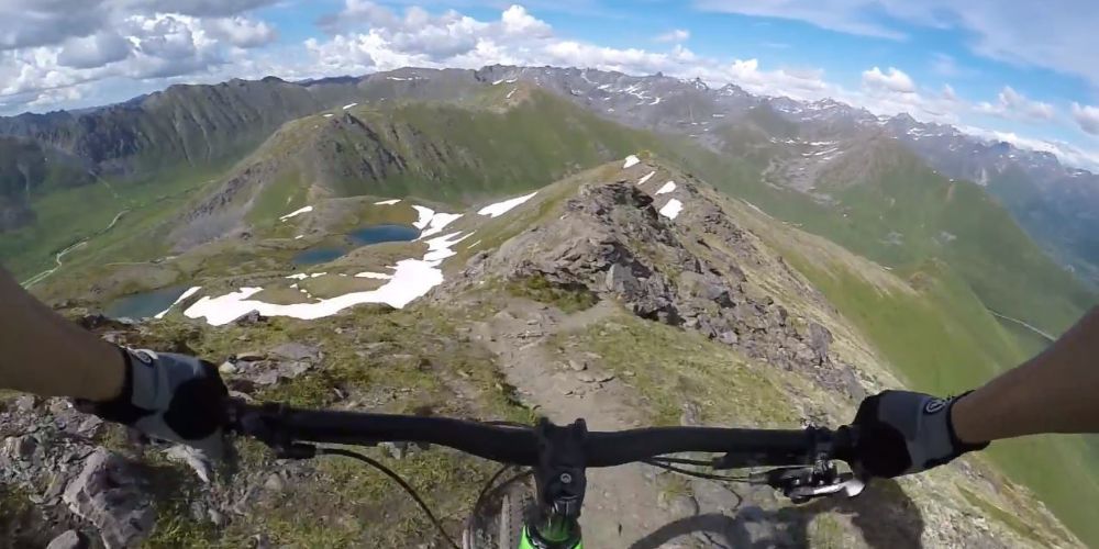 Cyclist on a mountain trail with Alaskan scenery