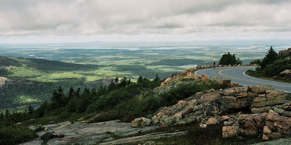 Cyclist riding along Maine's coastal trail