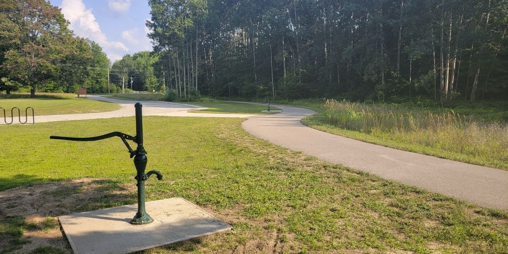 Cyclist riding along a lakefront path in Michigan