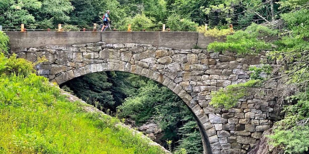 Cyclist riding along a mountain trail in New Hampshire