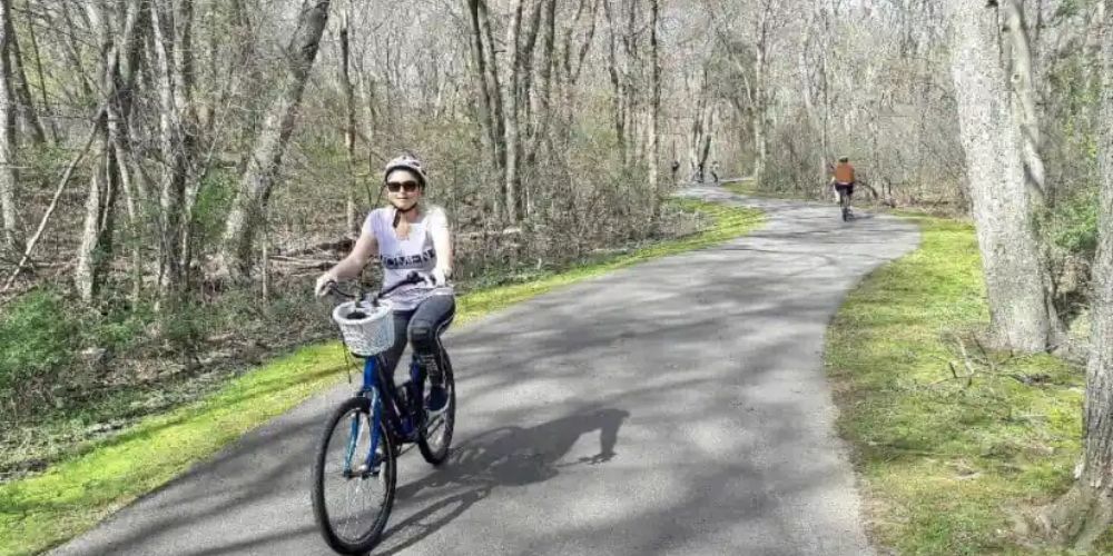 Cyclist riding along a coastal trail in Rhode Island