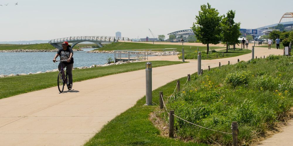 Cyclist biking along a lakeside trail in Wisconsin