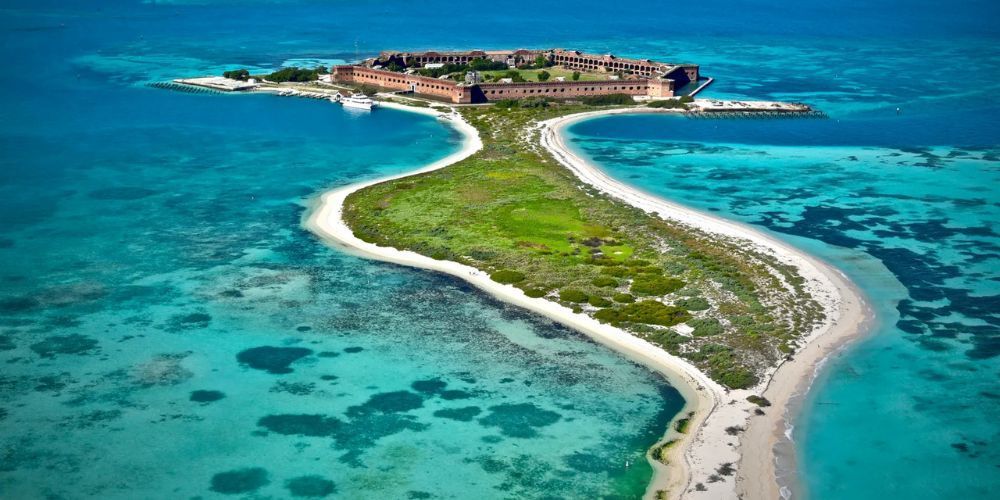 An aerial view of a small island in the middle of the ocean.