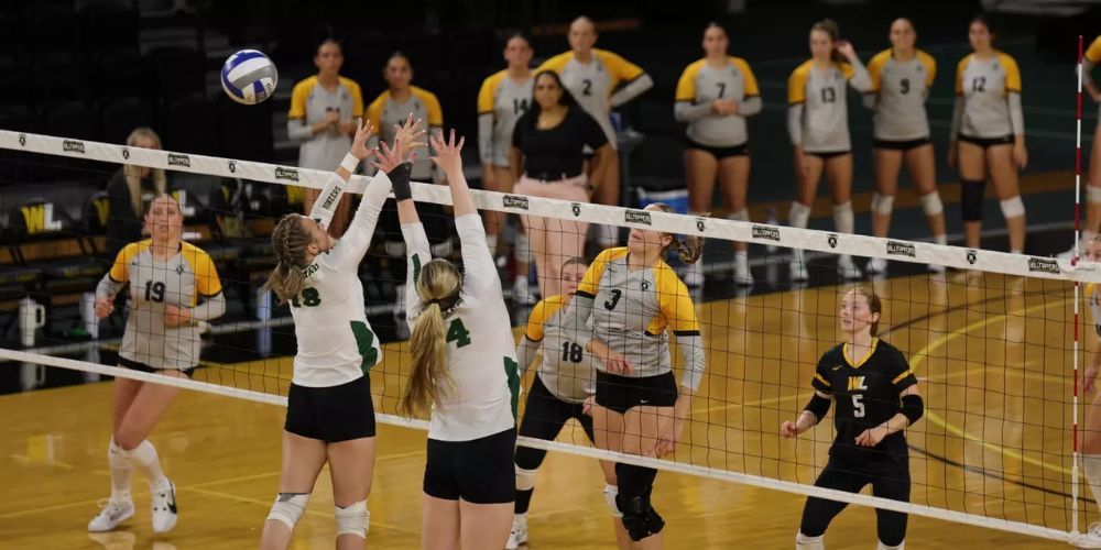 A group of women are playing volleyball on a court.