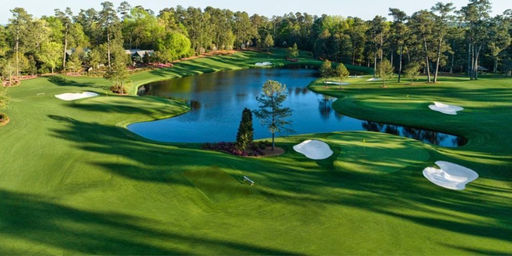 An aerial view of a golf course with a lake in the middle of it.