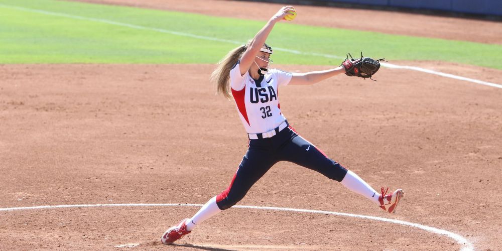 fastpitch softball pitcher in the wind up