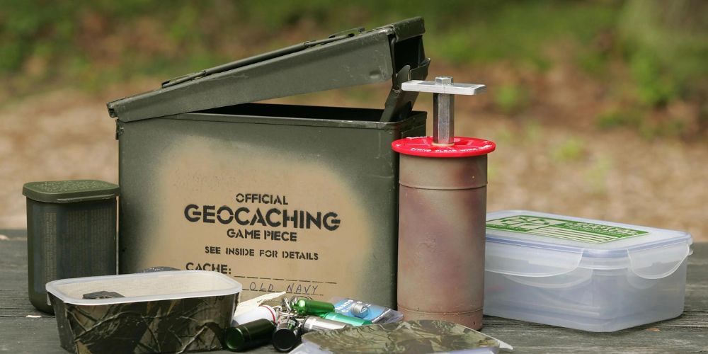 A box that says geocaching on it is sitting on a wooden table.