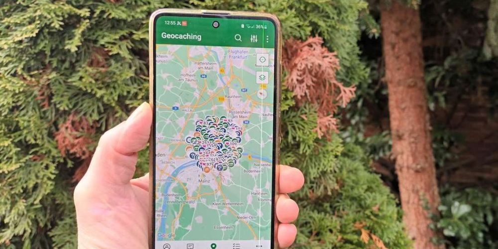 person looking at a geocaching app