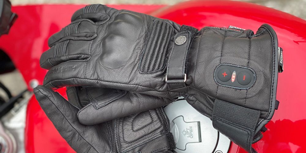 heated motorcycle gloves on the gas tank of a motorcycle