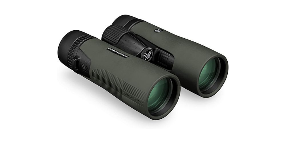 A pair of binoculars sitting on top of each other on a white surface.