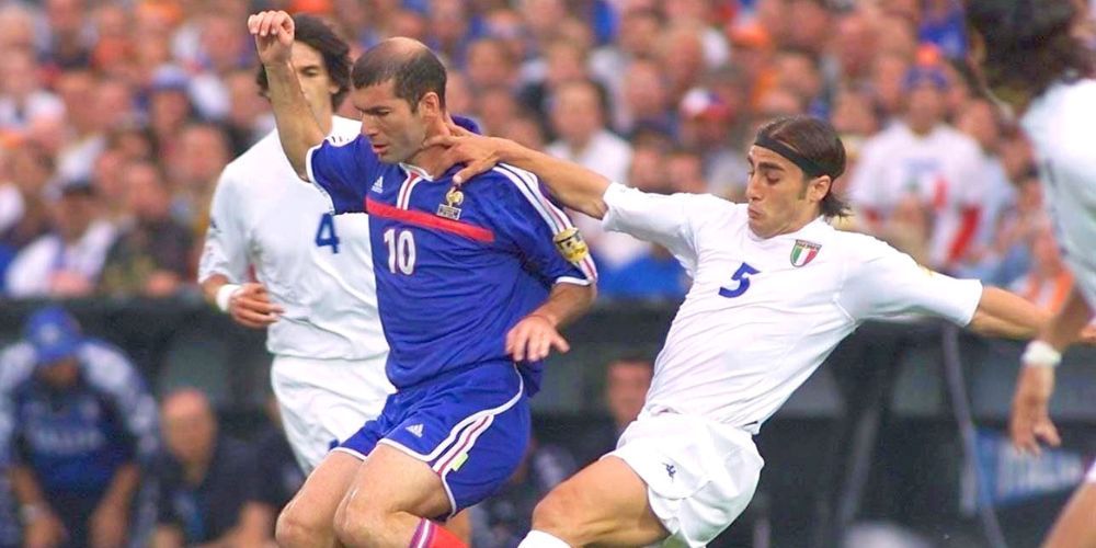 A group of soccer players are playing a game on a field.