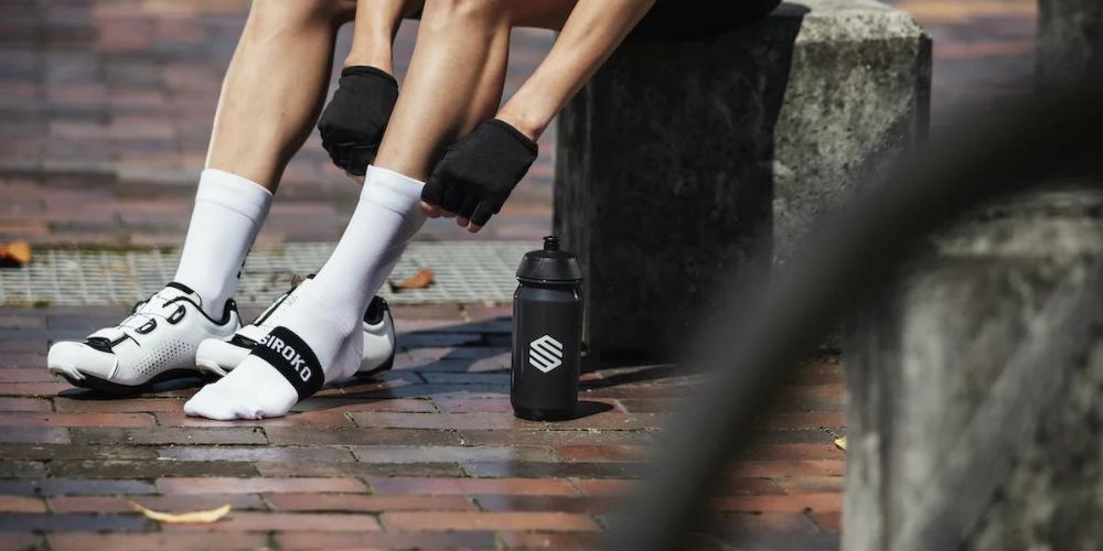 man pulling up his cycling socks