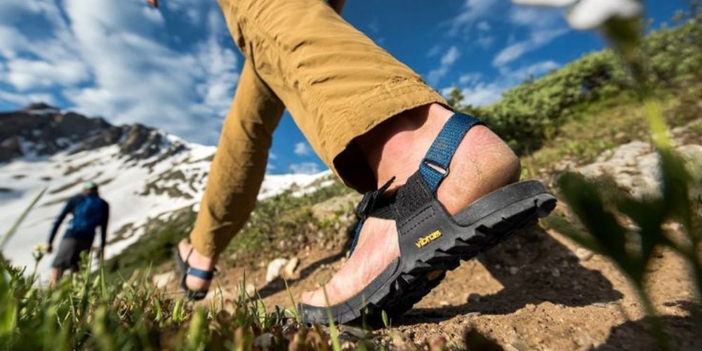 a man hiking in sandals