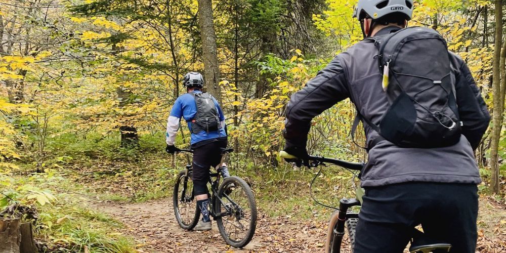 two mountain bikers with hydration packs