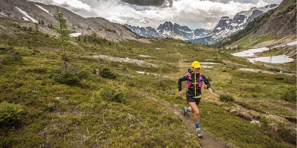 A person is running on a trail in the mountains.