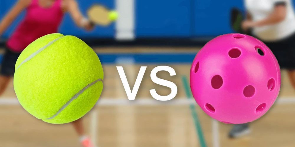 A yellow tennis ball and a pink paddleball are on a court.