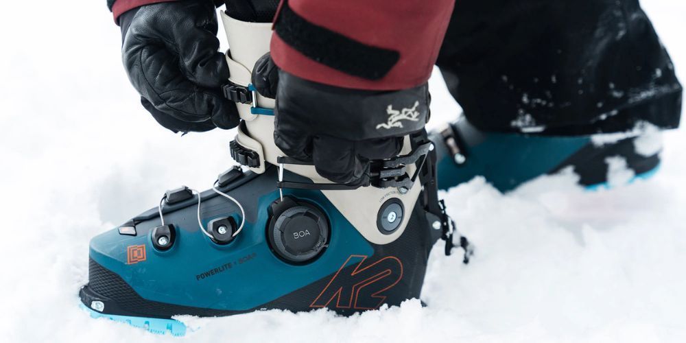 Close-up of a pair of ski boots on a snowy slope