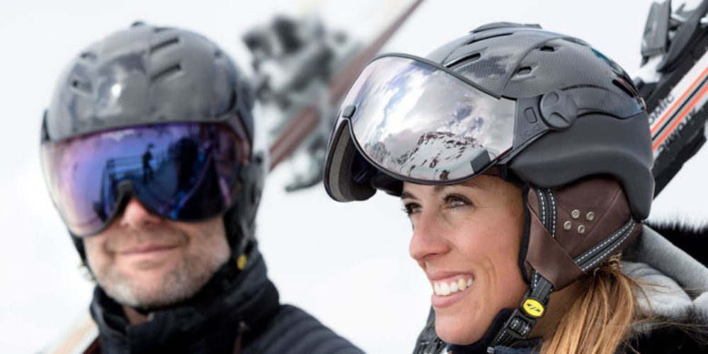 Close-up of a ski helmet with mountains in the background