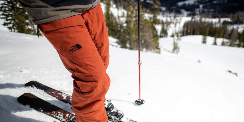 Pair of ski pants draped over a snowy rock