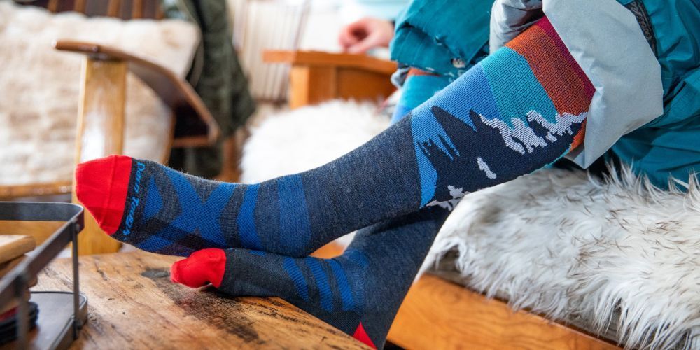 Pair of colorful ski socks on a snowy slope