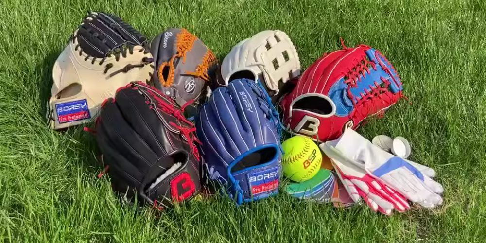 a group of softball gloves on the grass