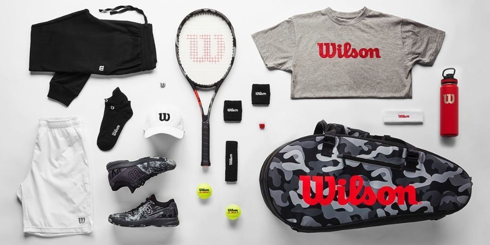 A variety of wilson tennis equipment is laid out on a table