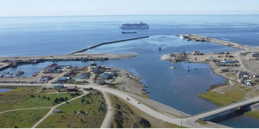 An aerial view of a harbor with a large ship in the distance.