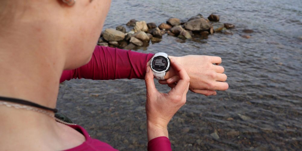 woman looking at her trail running gps watch