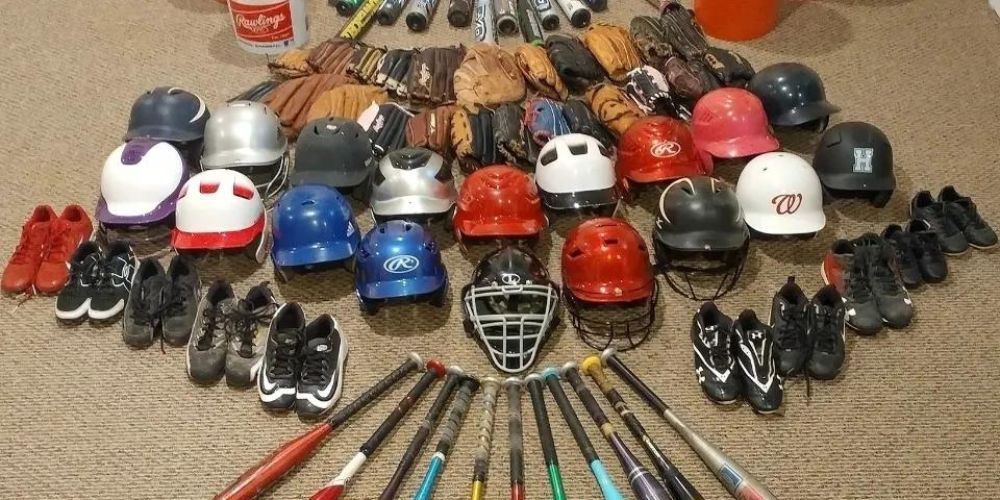 A bunch of softball equipment including helmets gloves shoes and bats