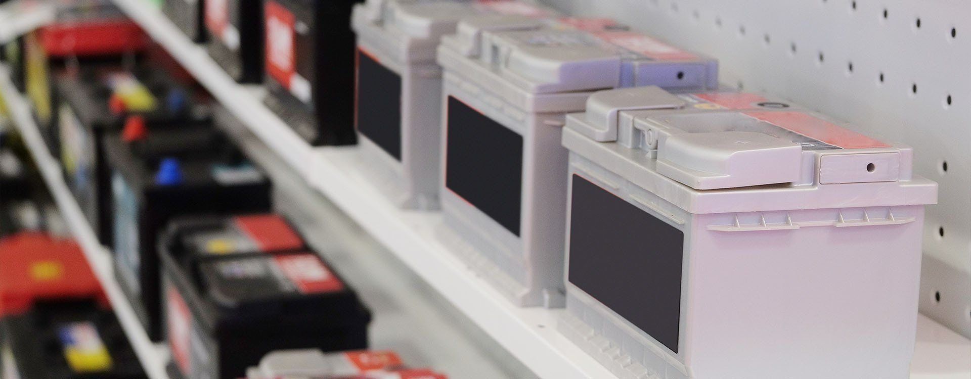Car Batteries on a Shelf in a Store — Paul’s Tyres & Farm Maintenance in Orange, NSW