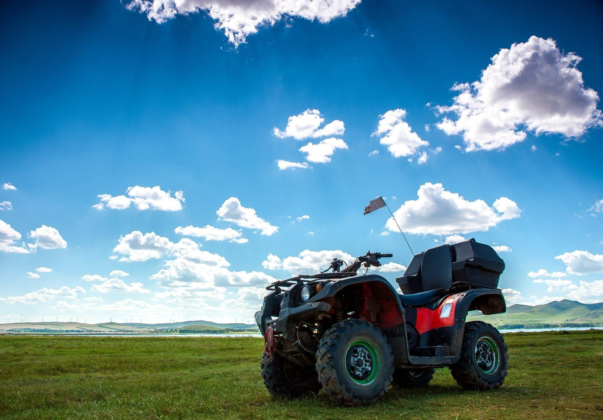 Atv on Green Field Under Blue Sky With Puffy Clouds — Paul’s Tyres & Farm Maintenance in Orange, NSW