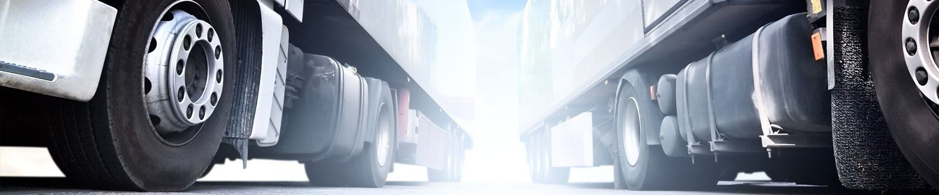 Two Trucks Face Each Other, Their Tires — Paul’s Tyres & Farm Maintenance in Apsley, NSW