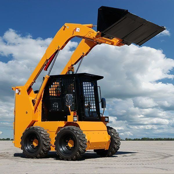 Yellow Skid-steer Loader With Raised Bucket Against a Blue Sky — Paul’s Tyres & Farm Maintenance in Apsley, NSW