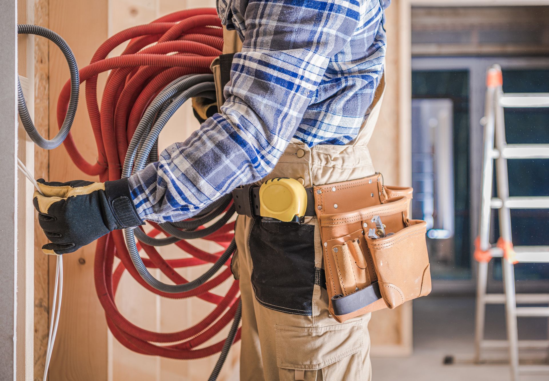 A man is holding a bunch of wires in his hands.