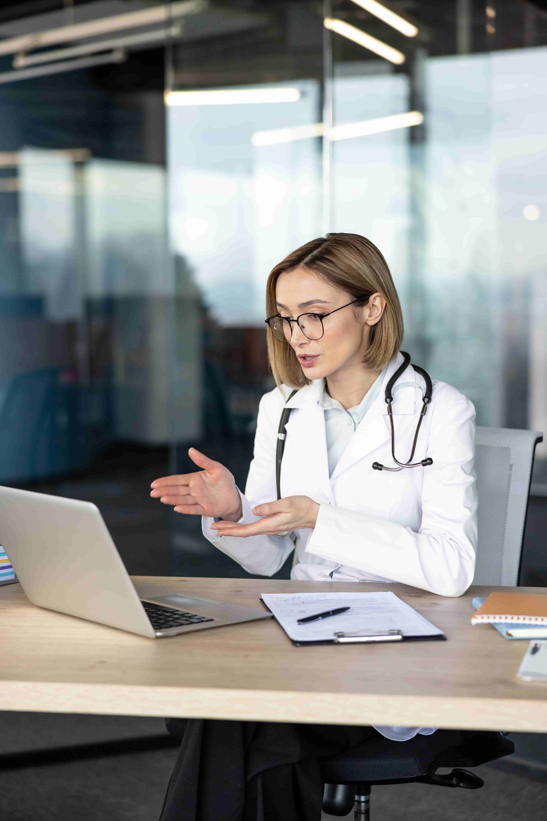 Therapist taking notes during a session with a patient seated on a black couch.