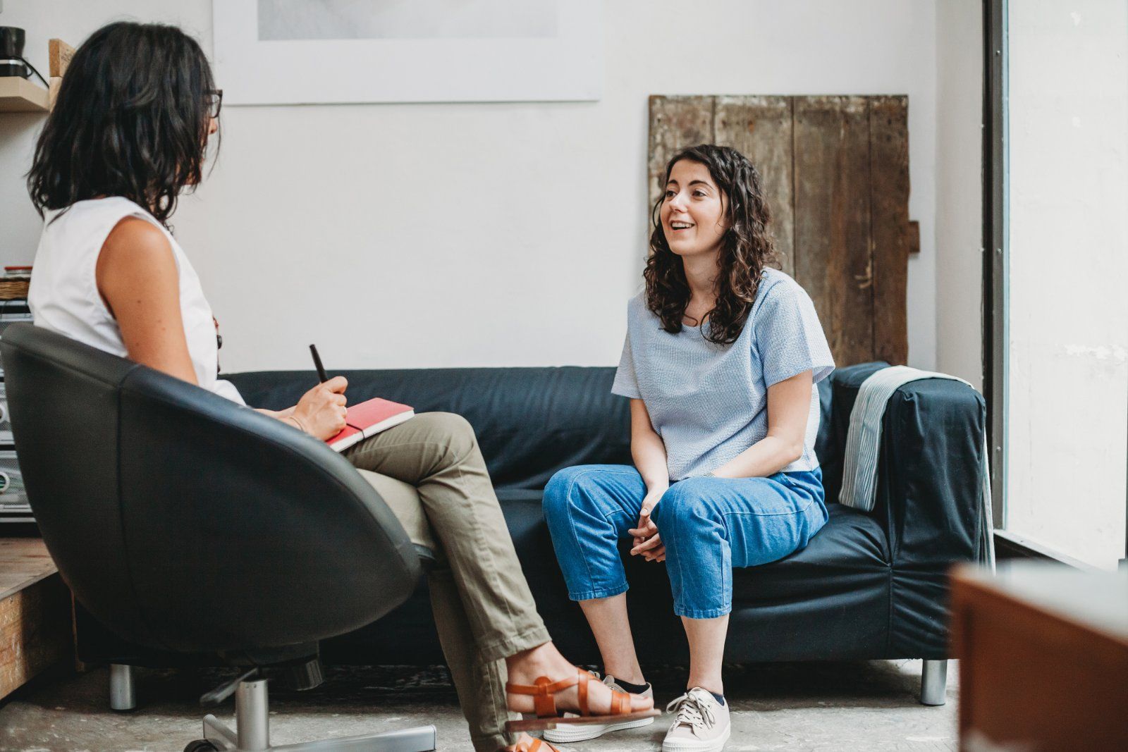 Woman talking to therapist in an office setting.