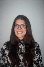 A man in a suit and white shirt is smiling for the camera.