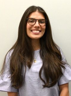 A man in a suit and white shirt is smiling for the camera.