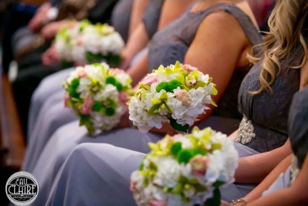 Bridesmaids holding colorful flowers