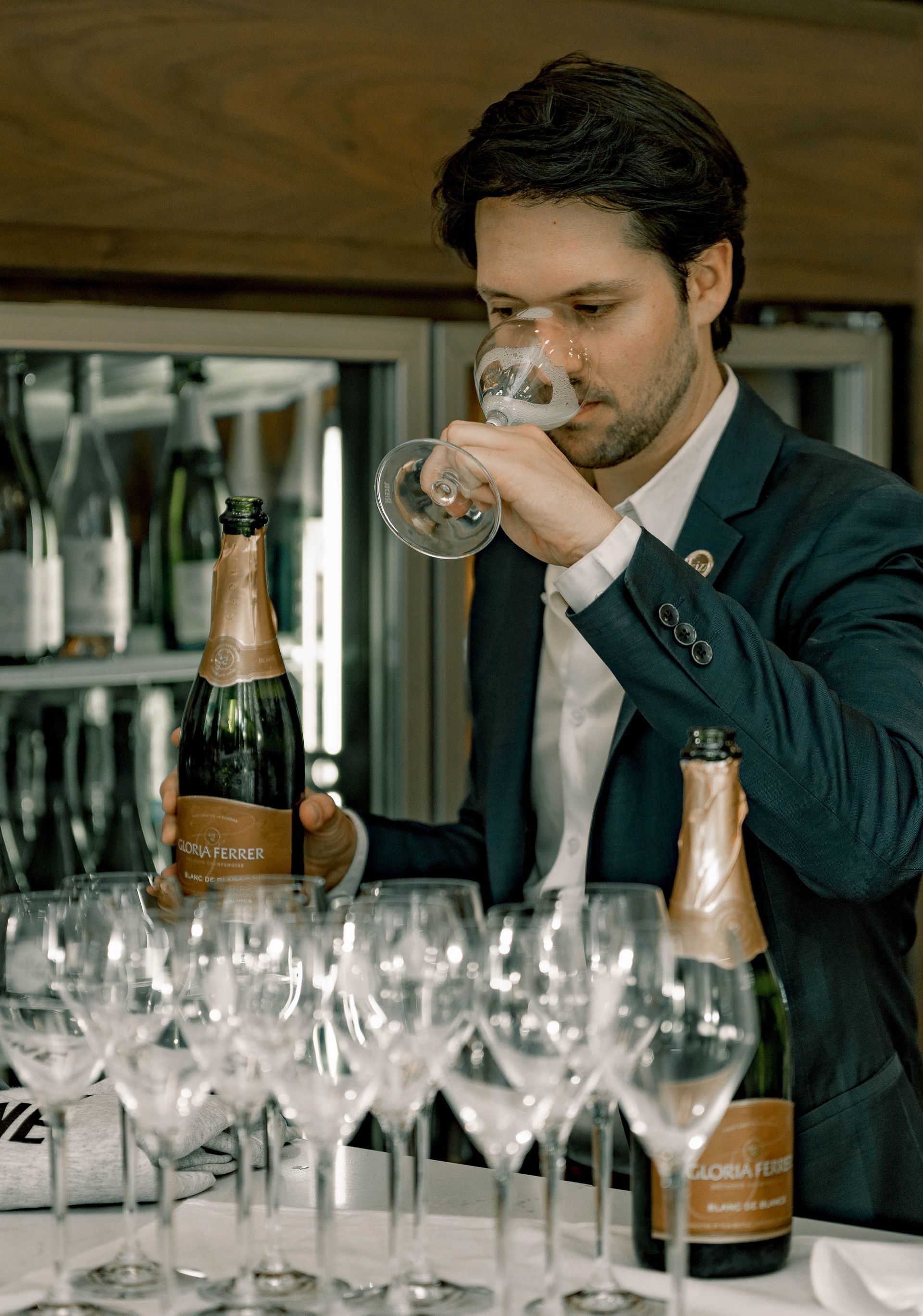 Chief champagne officer smelling a glass of champagne.