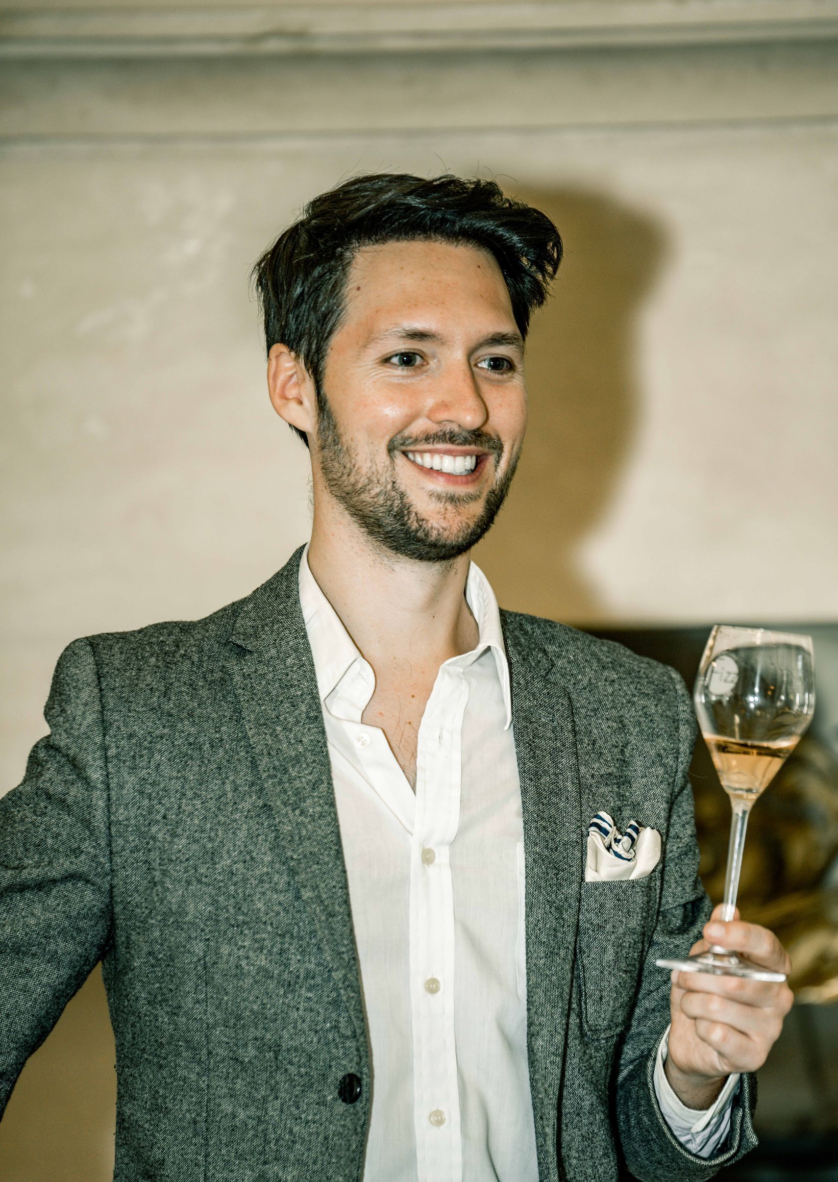 Chief champagne officer holding a glass of champagne.