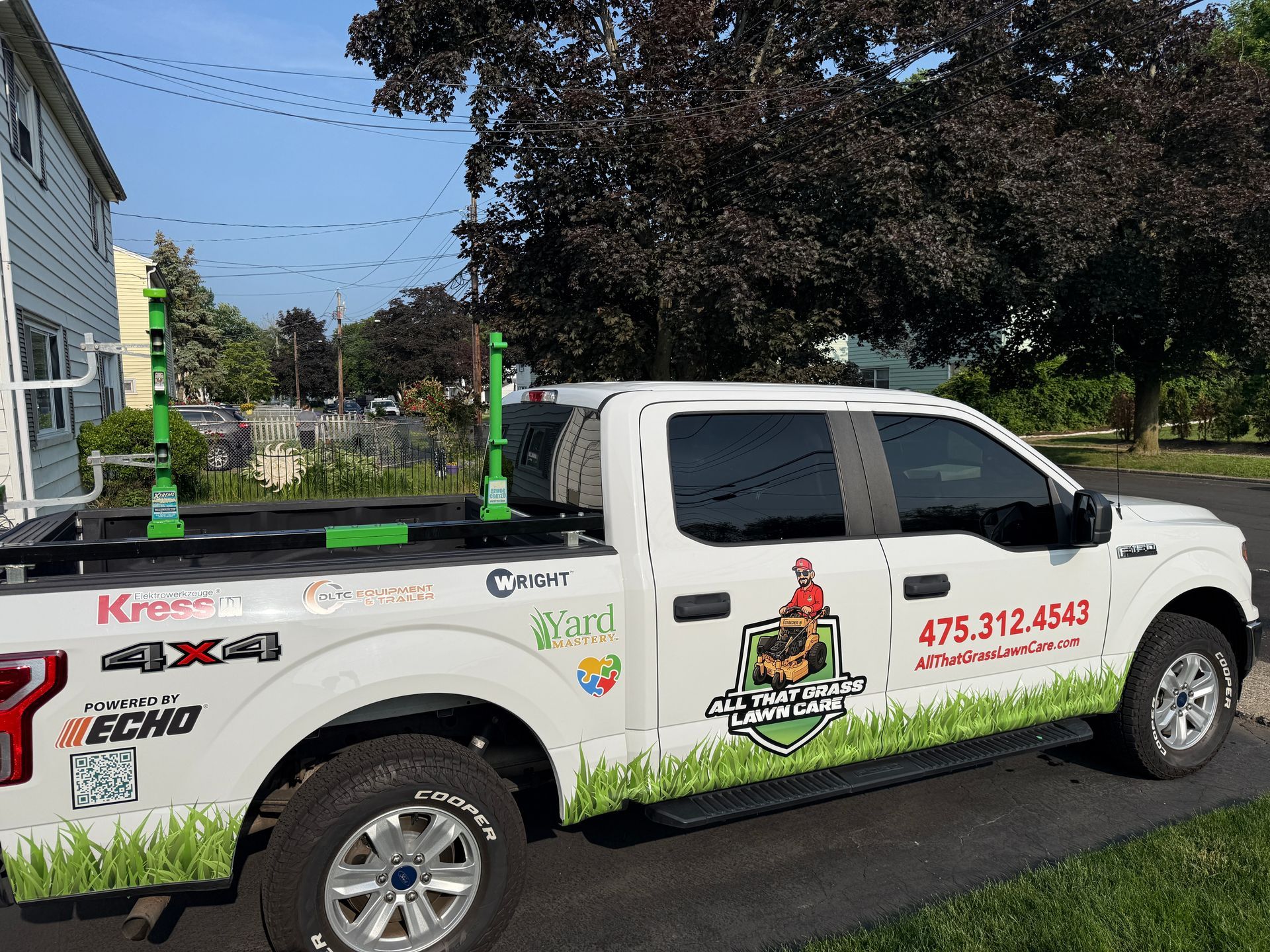 A white truck is parked in front of a house.