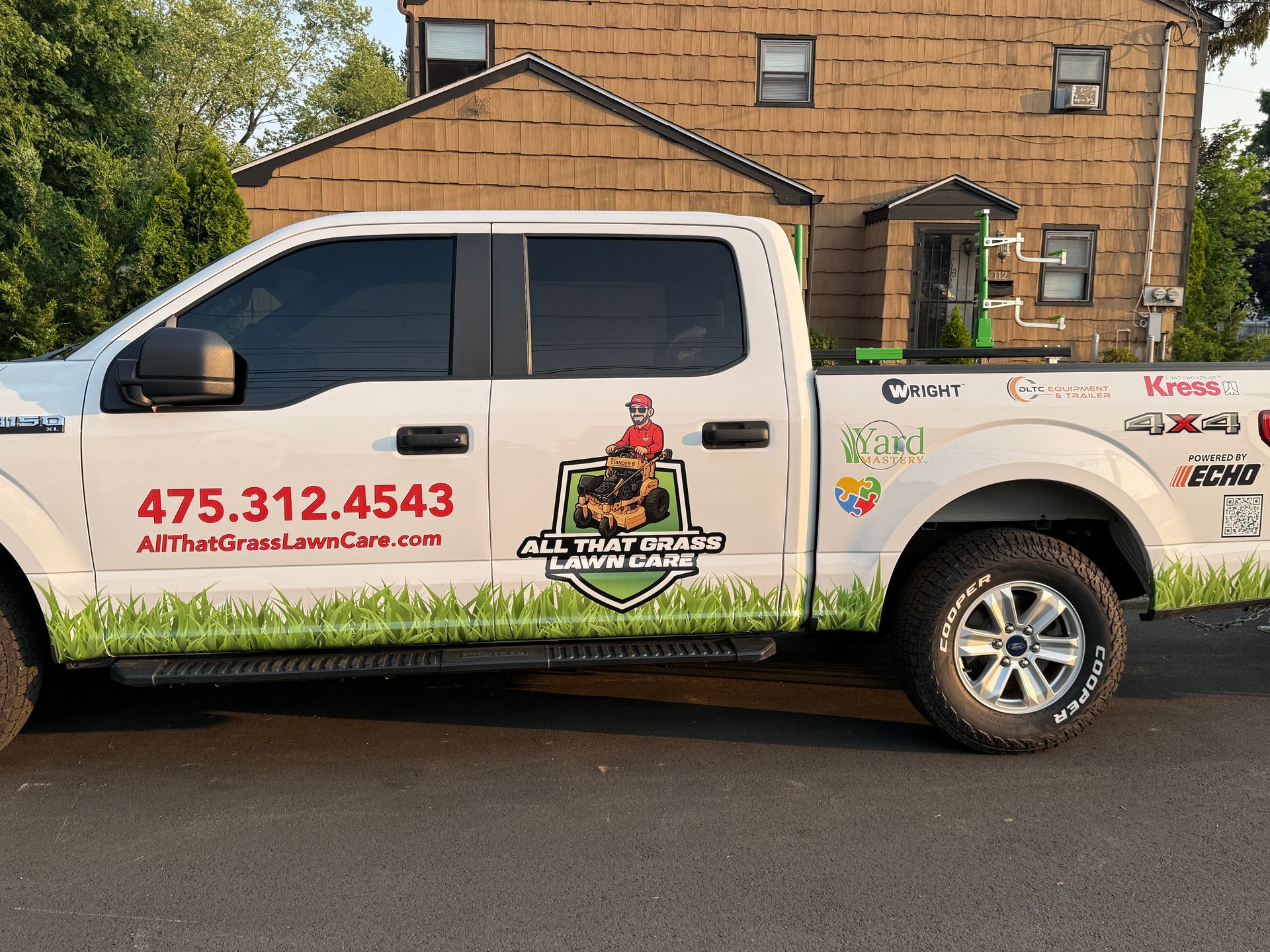 A white truck is parked in front of a house