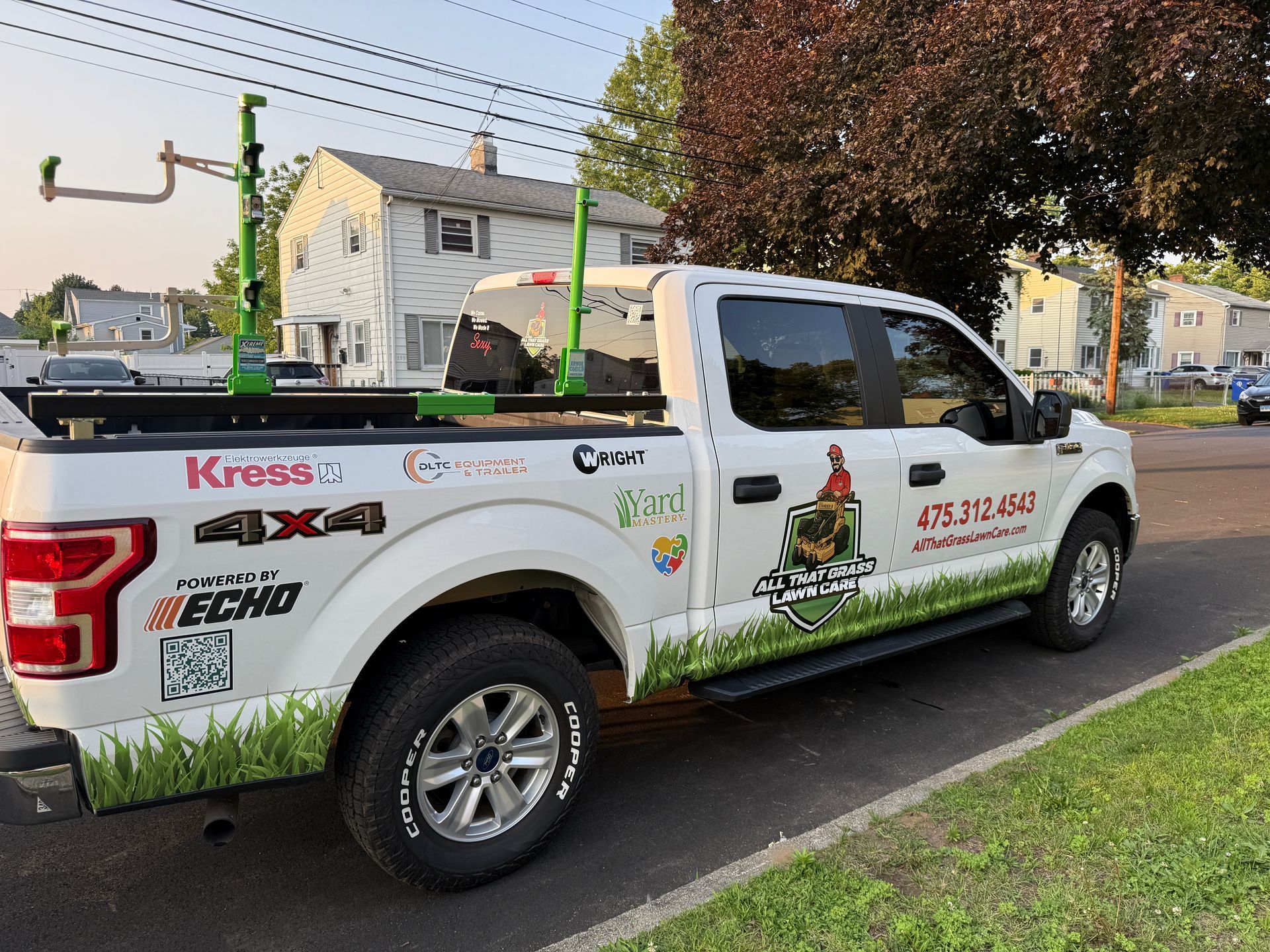 A white truck is parked on the side of the road.