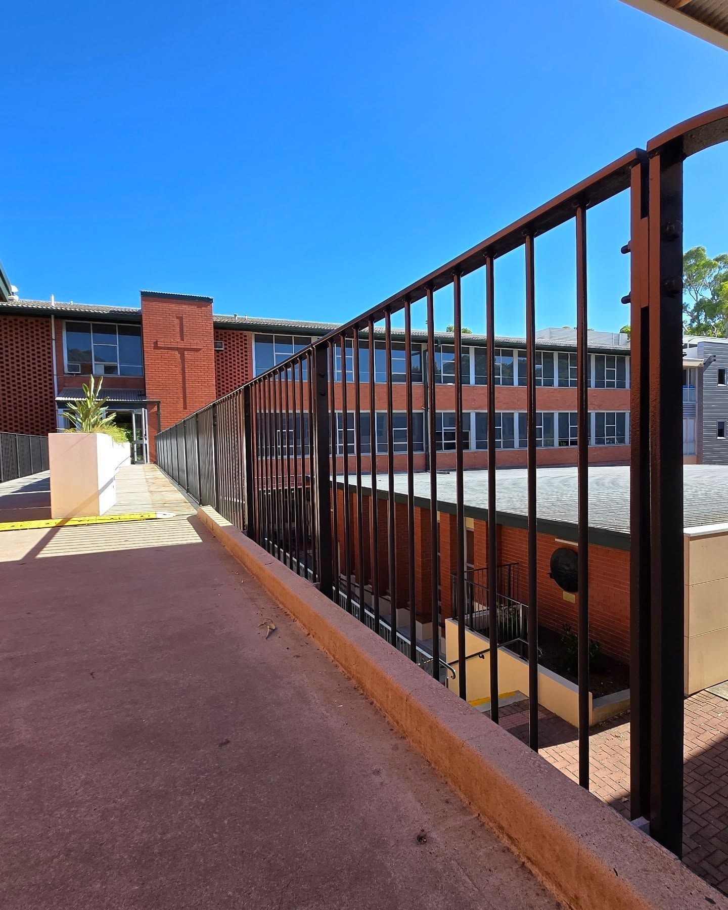 A building with a lot of windows and a green trash can