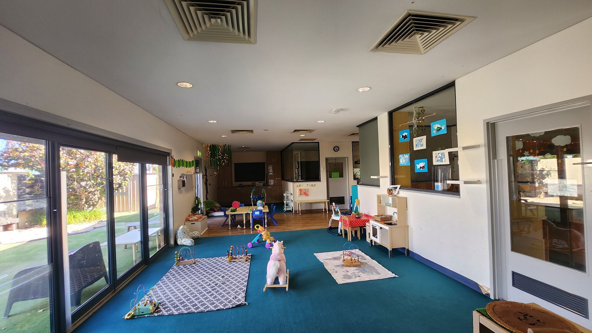 A man standing on a ladder inside of a building