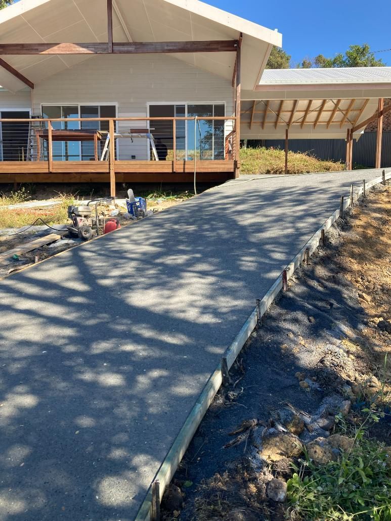 Concrete Driveway Is Built In Front Of A House — Northern Rivers Concrete Construction In Pimlico, NSW